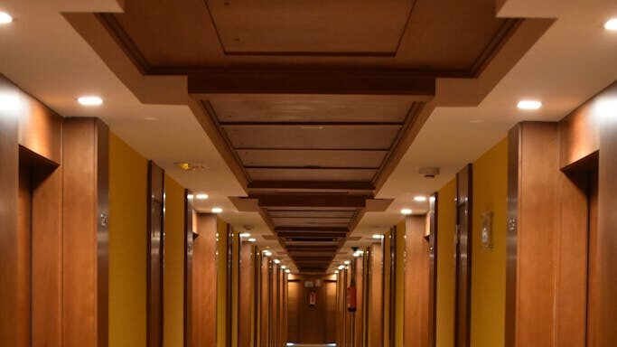 Turned-on Lights Along Hotel Hallway